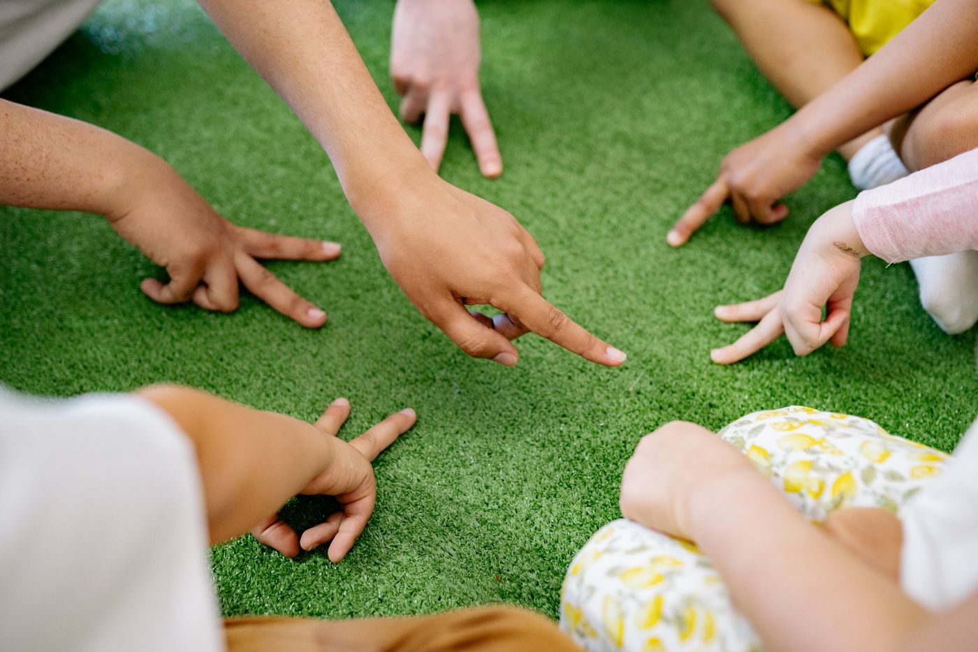 Children playing together outdoors on grass