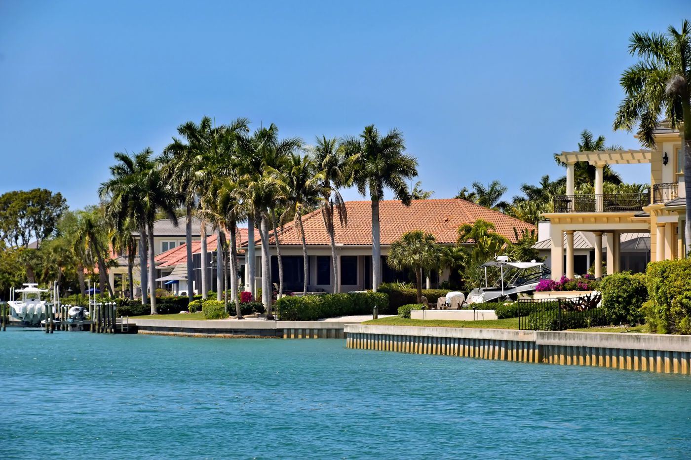 Waterfront villas along a canal under a blue sky