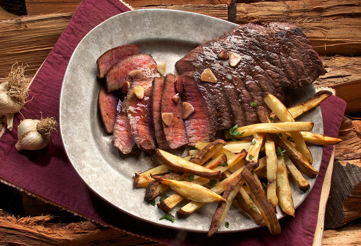 Sliced steak with fries, elegantly plated